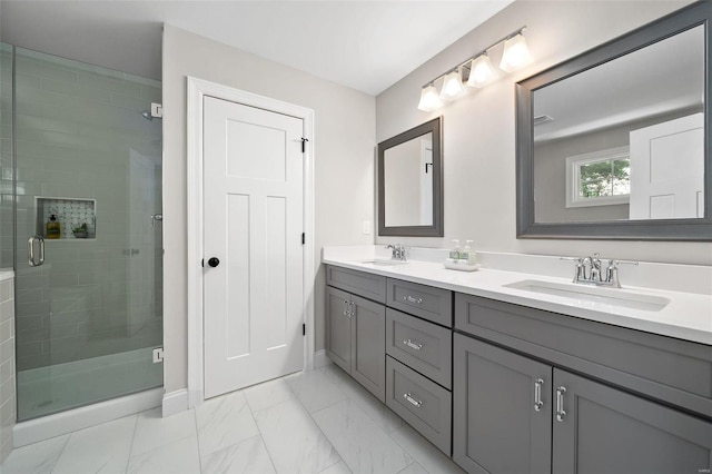 full bath with marble finish floor, a sink, and a shower stall