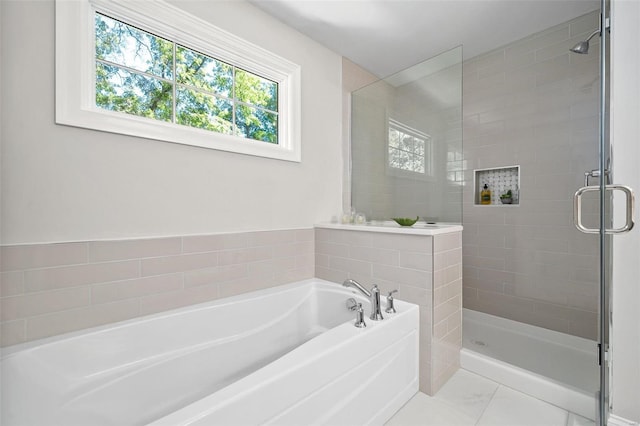 bathroom featuring marble finish floor, a shower stall, and a bath