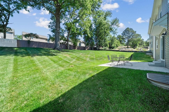 view of yard with fence and a patio