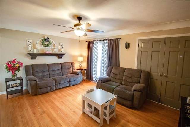 living room featuring ceiling fan and wood finished floors