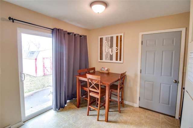 dining area featuring baseboards