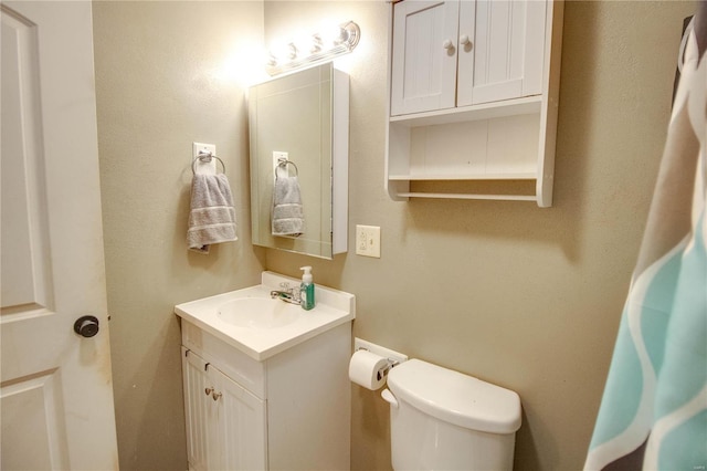 bathroom featuring toilet and vanity