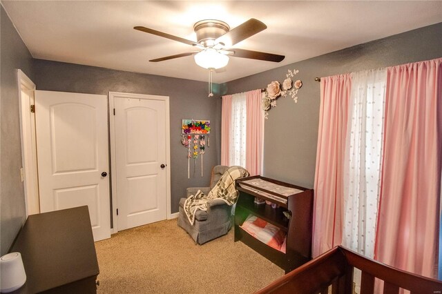 interior space with a ceiling fan and carpet flooring