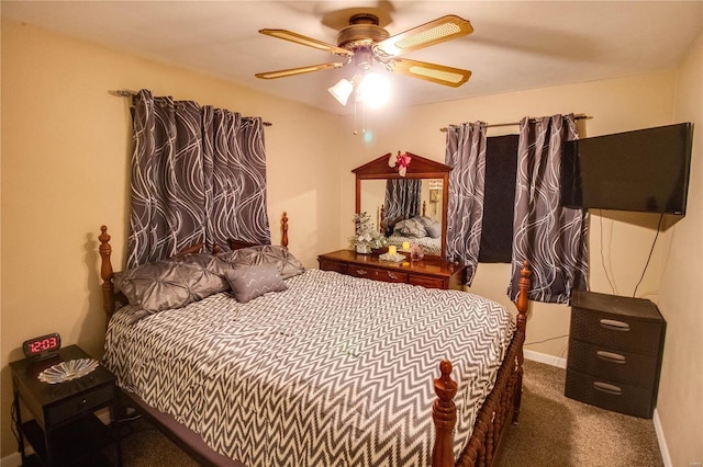 bedroom with dark colored carpet, ceiling fan, and baseboards