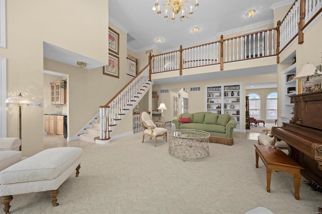 living room featuring built in shelves, light colored carpet, ornamental molding, baseboards, and stairs