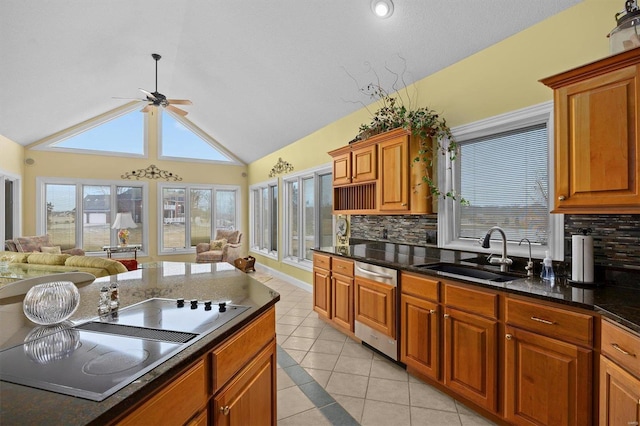 kitchen with electric stovetop, a sink, open floor plan, stainless steel dishwasher, and brown cabinetry