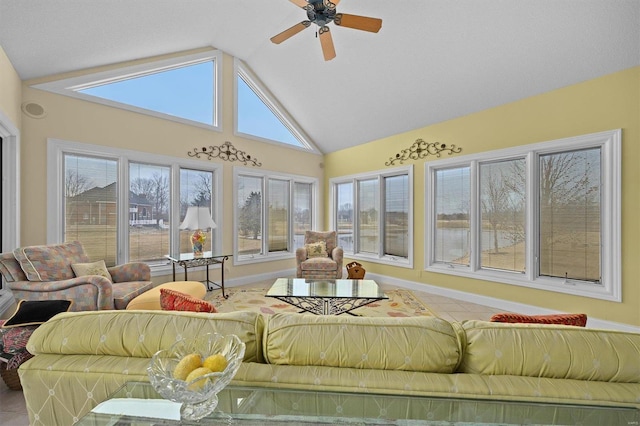 sunroom featuring lofted ceiling and a ceiling fan