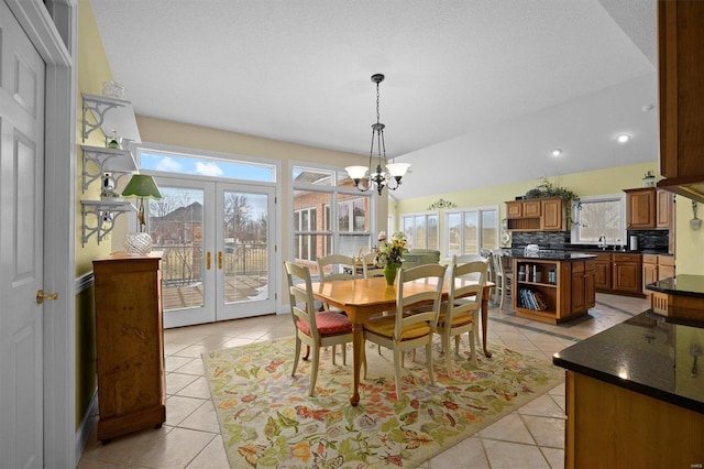 dining room with a healthy amount of sunlight, light tile patterned floors, and french doors