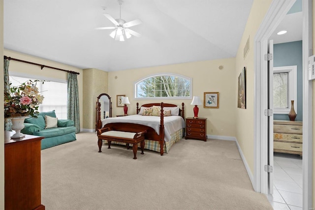 bedroom featuring light colored carpet, visible vents, vaulted ceiling, and baseboards