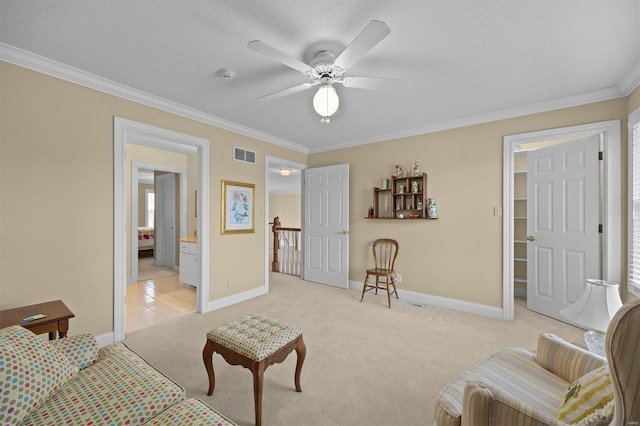 bedroom featuring a textured ceiling, light colored carpet, visible vents, baseboards, and crown molding