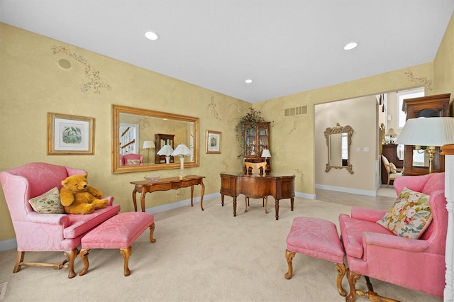 living area with light carpet, recessed lighting, visible vents, and baseboards