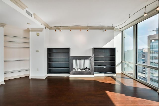 unfurnished living room with a fireplace, wood finished floors, visible vents, and baseboards