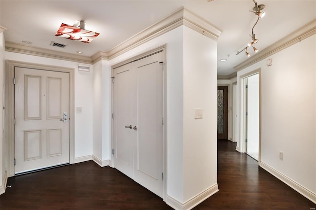 entrance foyer with visible vents, baseboards, dark wood-type flooring, and crown molding