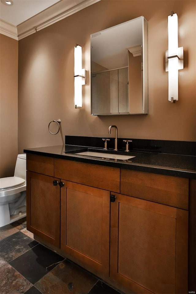 bathroom featuring vanity, toilet, and crown molding