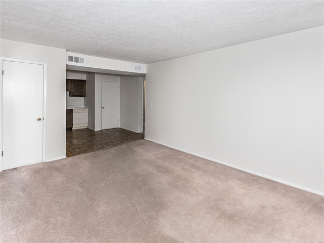 empty room featuring carpet floors and a textured ceiling