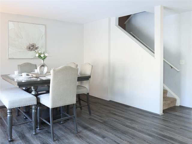 dining room featuring wood finished floors and stairs