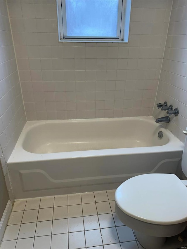 bathroom with tile patterned floors, toilet, and tub / shower combination