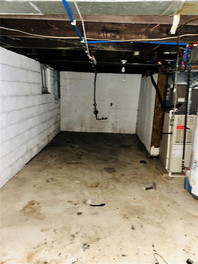 unfinished basement featuring heating unit