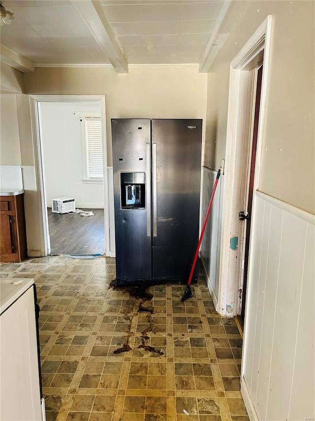 kitchen featuring a wainscoted wall, beamed ceiling, and stainless steel fridge with ice dispenser