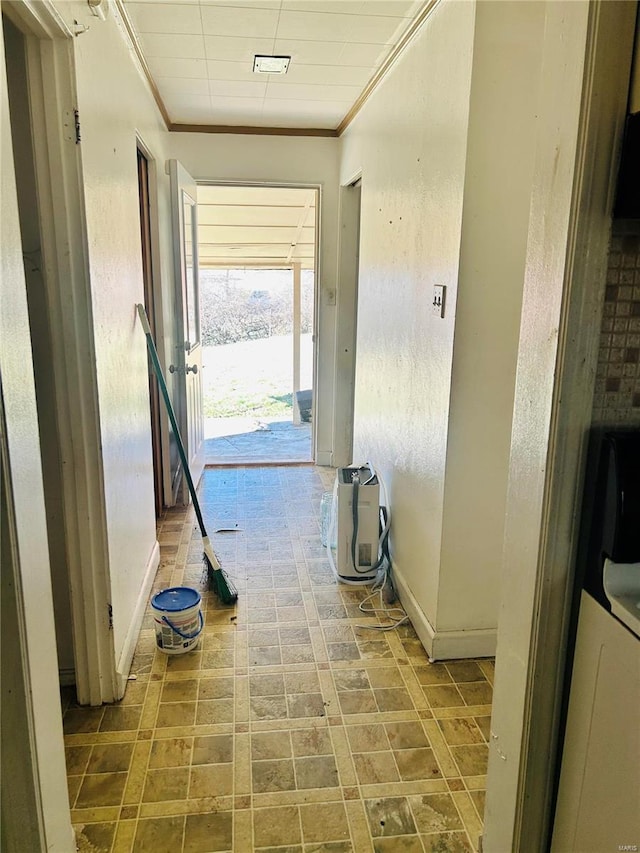 corridor featuring baseboards and ornamental molding