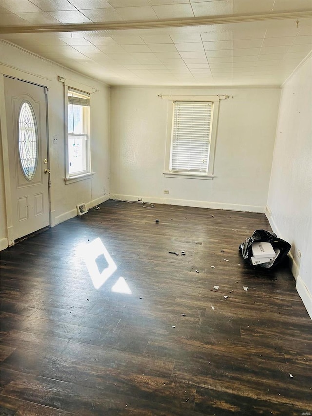 foyer with baseboards and dark wood-style flooring