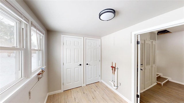 interior space featuring light wood-type flooring and baseboards