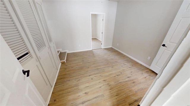 unfurnished bedroom with light wood finished floors and baseboards