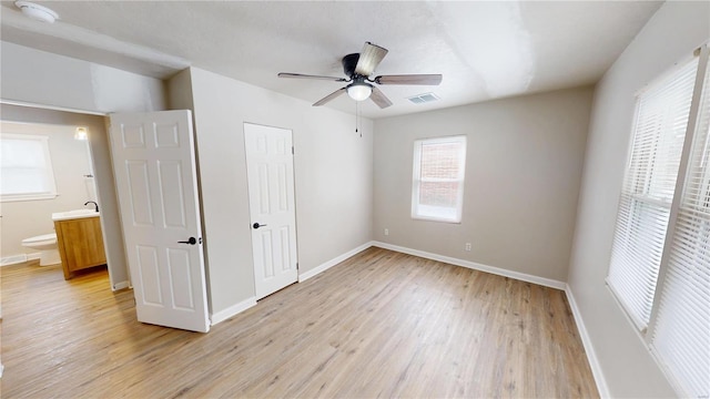 unfurnished bedroom featuring light wood-type flooring, baseboards, and visible vents