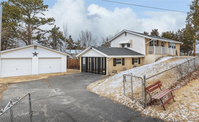 view of front of home featuring a garage and an outbuilding