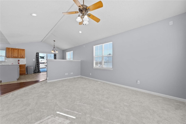 unfurnished living room featuring recessed lighting, light colored carpet, a ceiling fan, baseboards, and vaulted ceiling