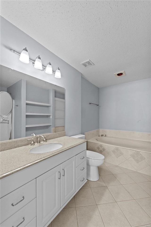 bathroom featuring a textured ceiling, visible vents, tile patterned flooring, and a bath