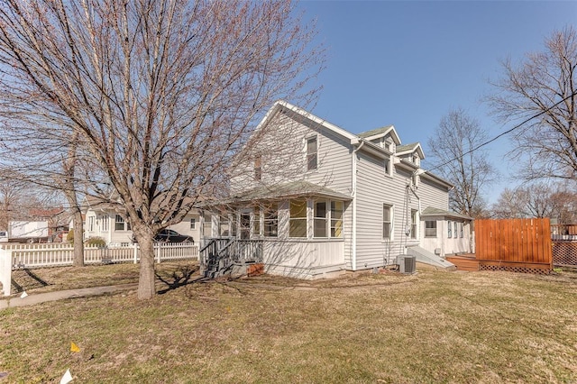 view of side of property featuring a lawn, cooling unit, and fence