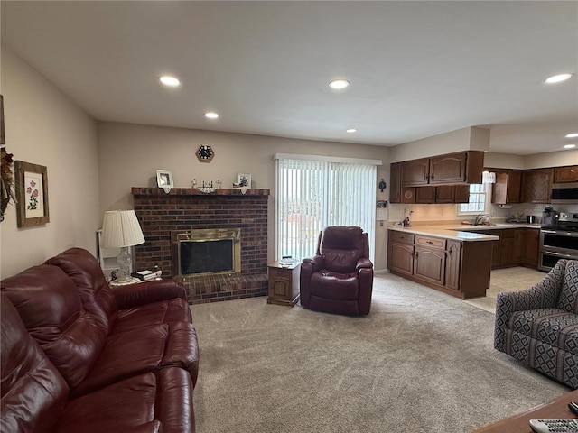 living area with a fireplace, light colored carpet, and recessed lighting