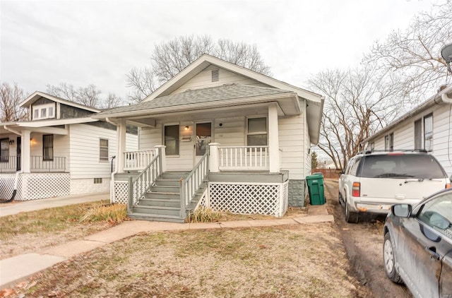 view of front of property featuring a porch and roof with shingles