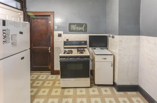 kitchen featuring white appliances and light floors