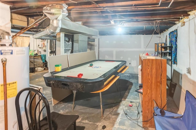 rec room with water heater and unfinished concrete flooring