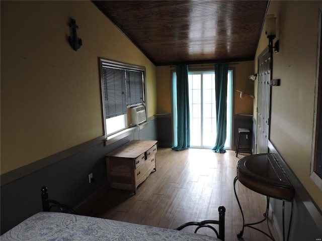 interior space with vaulted ceiling, cooling unit, wood ceiling, and light wood-style floors