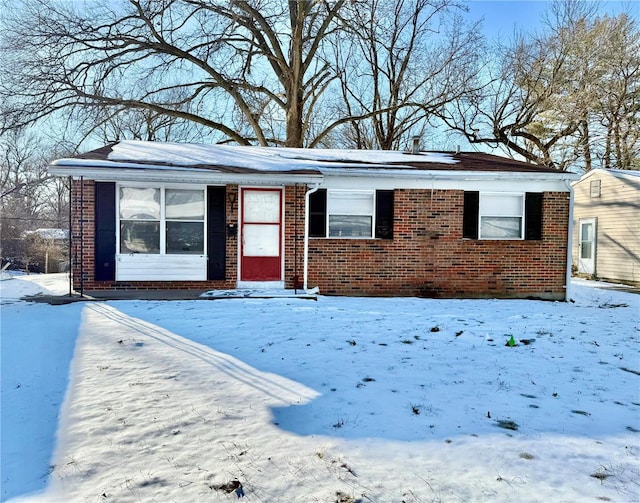 ranch-style house featuring brick siding