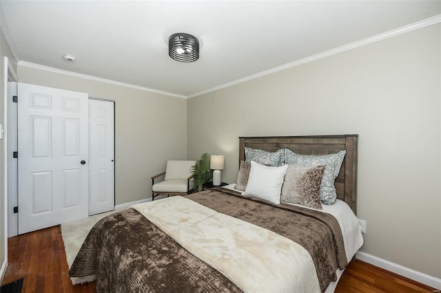 bedroom featuring dark wood-style floors, ornamental molding, visible vents, and baseboards