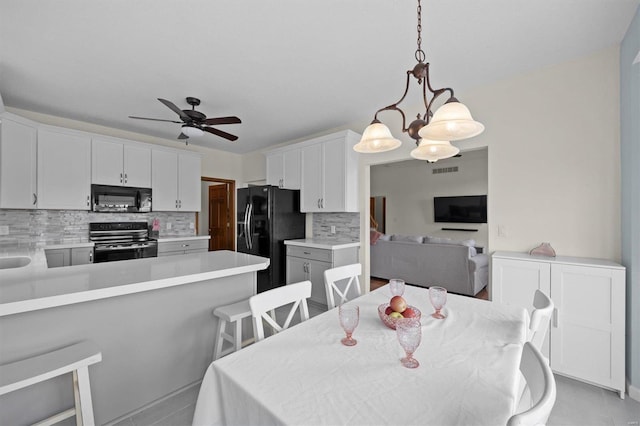 dining space featuring a ceiling fan, visible vents, and light tile patterned floors