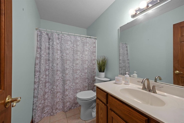 bathroom with toilet, tile patterned flooring, a textured ceiling, and vanity