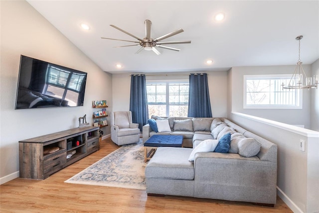 living room featuring lofted ceiling, a healthy amount of sunlight, and wood finished floors