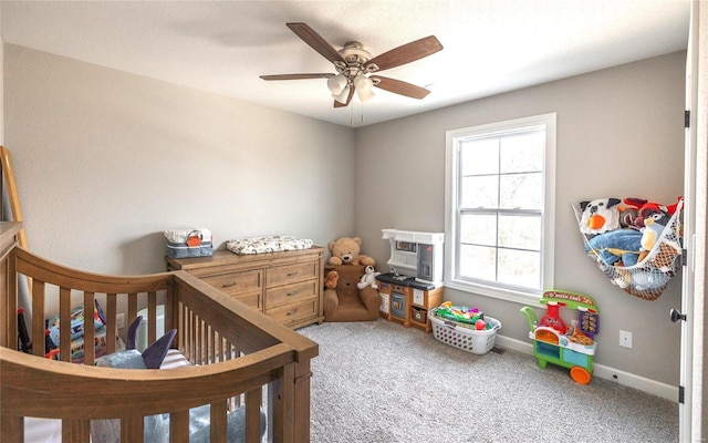 carpeted bedroom with a ceiling fan and baseboards