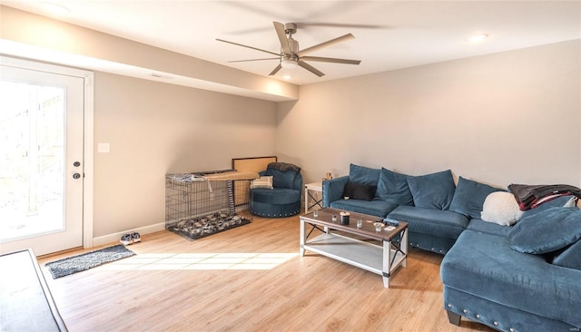 living room featuring visible vents, ceiling fan, baseboards, and wood finished floors