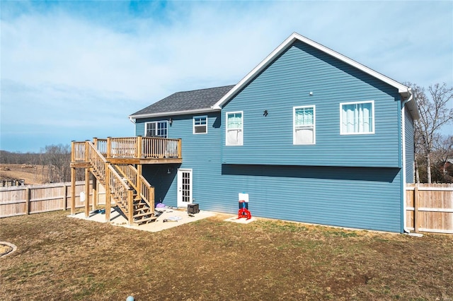 back of house with a yard, a fenced backyard, stairs, and a wooden deck