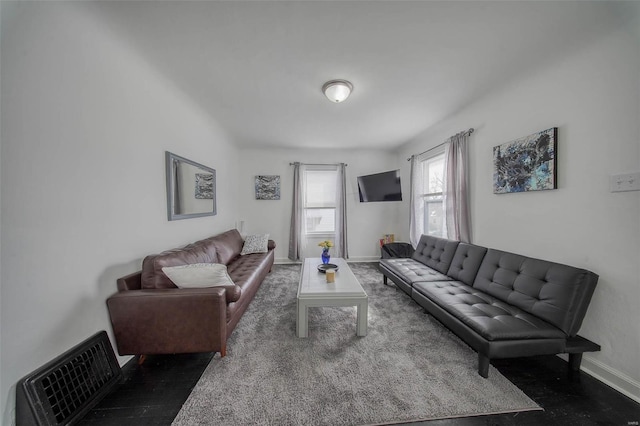 living room with visible vents and baseboards