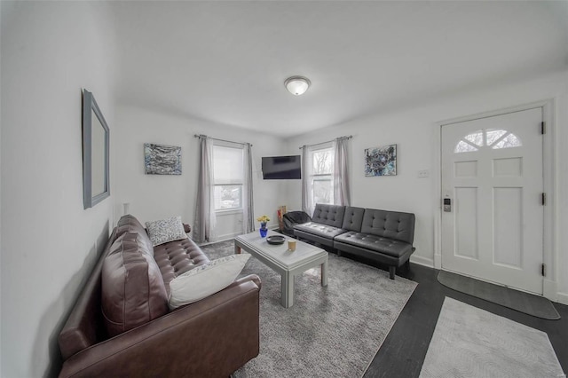 living area featuring baseboards