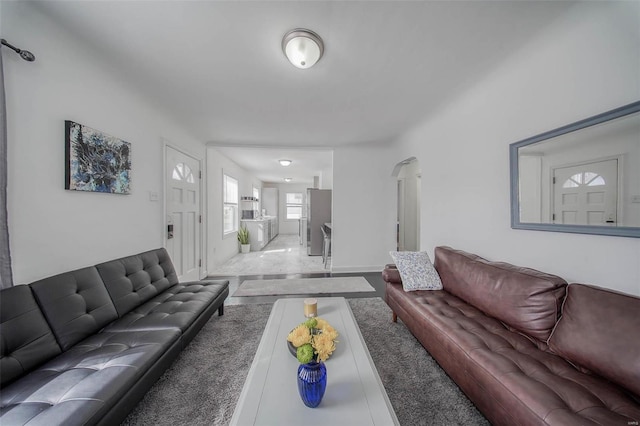 living room featuring arched walkways