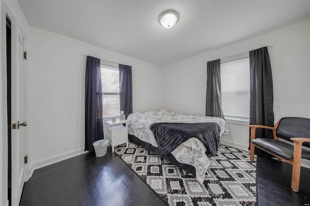 bedroom featuring wood finished floors and baseboards