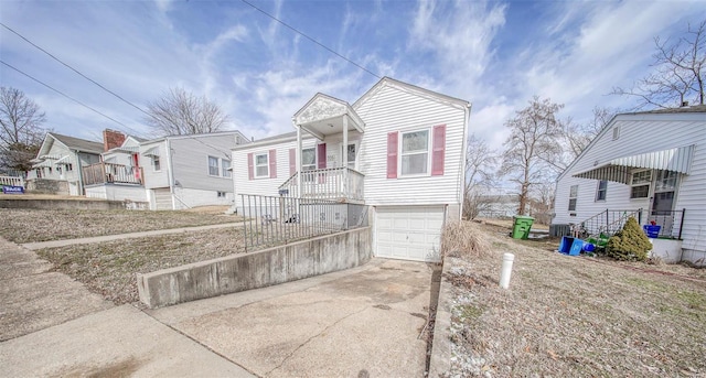 view of front of property featuring a garage, a residential view, and driveway